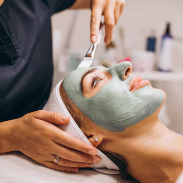 A woman receiving a Hydro Boost facial treatment at Kaya by Reema Salon, showcasing anti-aging and organic peel services.